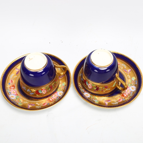 188 - A pair of 19th century blue and gilt porcelain cups and saucers, with hand painted bands of spring f... 