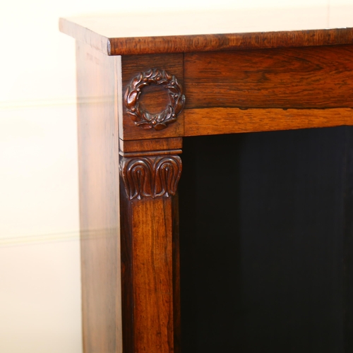 196 - A Regency rosewood open bookcase of small size, with carved laurel wreath bosses and acanthus carved... 