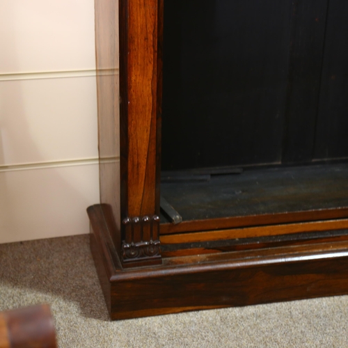 196 - A Regency rosewood open bookcase of small size, with carved laurel wreath bosses and acanthus carved... 