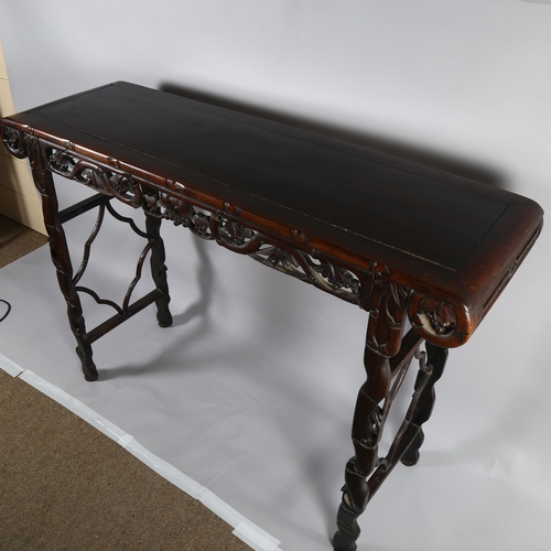 199 - A Chinese 19th century rosewood altar table, with grapevine carved and pierced frieze on carved supp... 