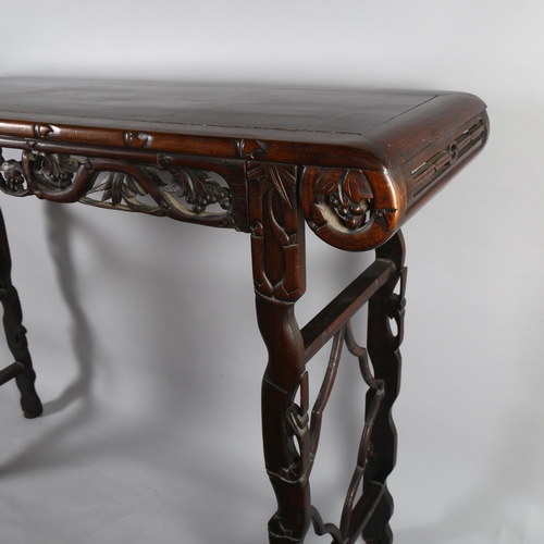 199 - A Chinese 19th century rosewood altar table, with grapevine carved and pierced frieze on carved supp... 