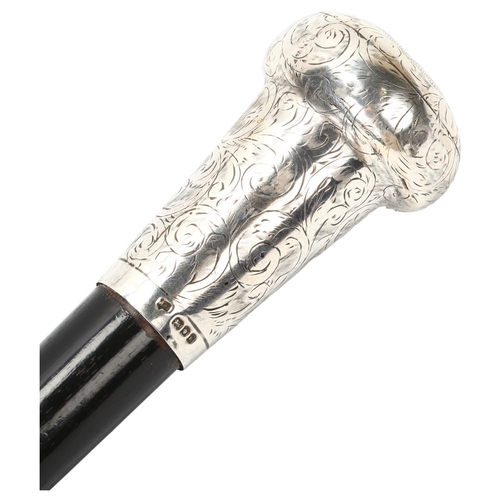 24 - An Ebony walking cane with large hand engraved silver top, hallmarked London 1925/6, length 92cm