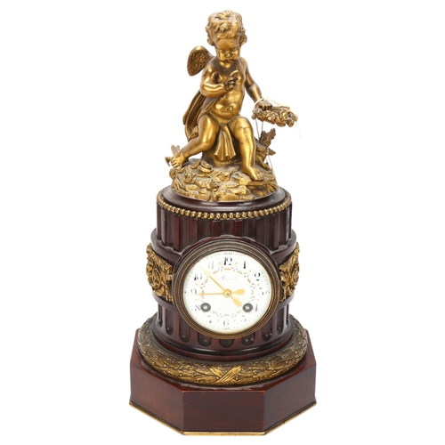 36 - A French late 19th century mahogany and gilt-bronze mounted column-shaped mantel clock, surmounted b... 