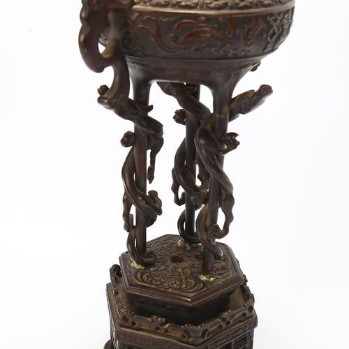 37 - A Chinese bronze incense burner converted to a lamp, with cast scrolled handles, raised on hexagonal... 