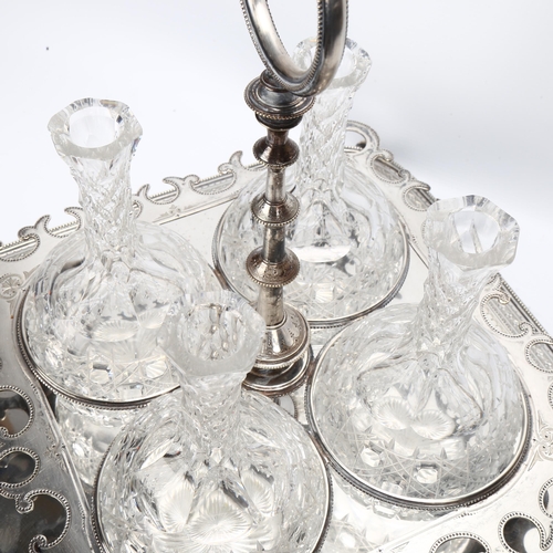 38 - A 19th century electroplate drinks stand holding 4 cut-glass decanters, the stand having an engraved... 