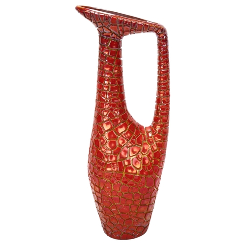 49 - Zsolnay Pecs, Hungary, a red lustre crackle glaze ewer, makers stamp to base, height 31cm