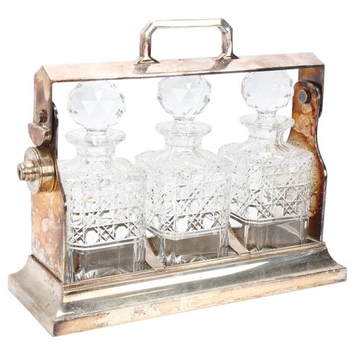 5 - An Art Deco electroplate 3-bottle tantalus, with cut-glass decanters, length 34cm