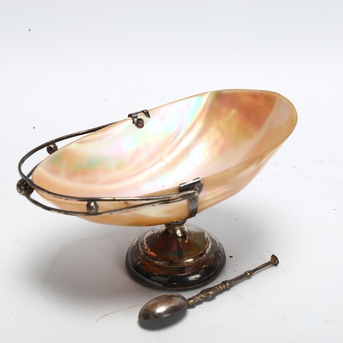 61 - A silver-mounted abalone shell bon bon basket with swing handle, length 12cm, with silver spoon