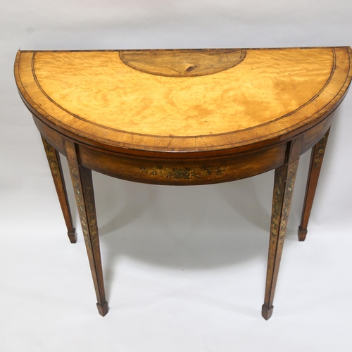 75 - A 19th century satinwood demi-lune fold over card table, with rosewood inlaid top, the base having b... 