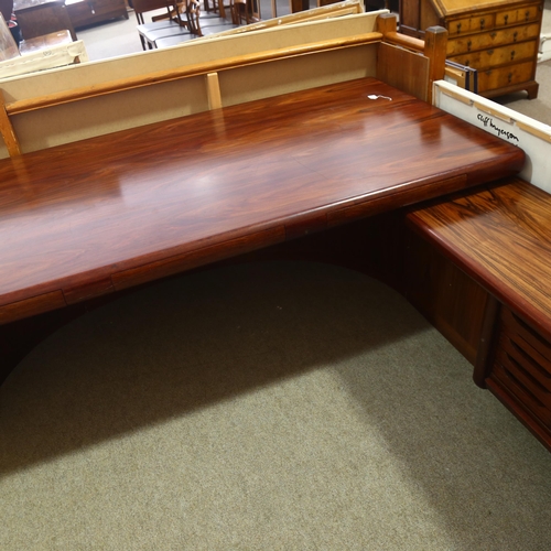 77 - Dyrlund, Denmark, a 1980s' Super Skyline santos-rosewood executive desk, with 3 inset drawers, on cu... 