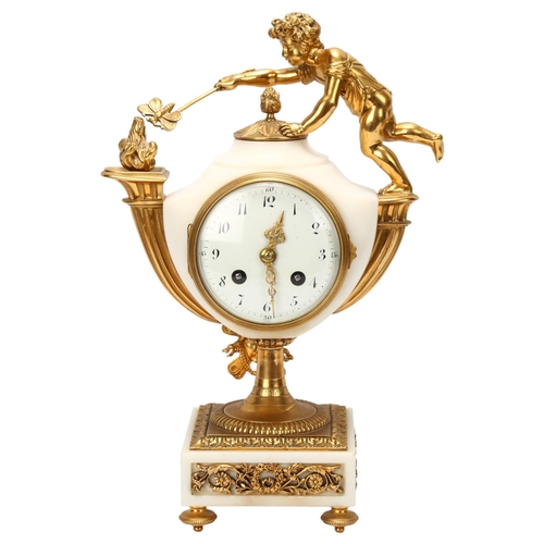 9 - A French alabaster and gilt-bronze mounted mantel clock, surmounted by a child holding a moth to a f... 