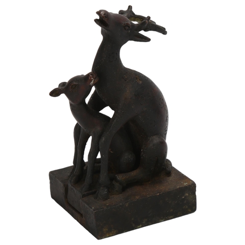 90 - A Chinese patinated bronze desk seal, in the form of 2 interlocking deer, height 11.5cm