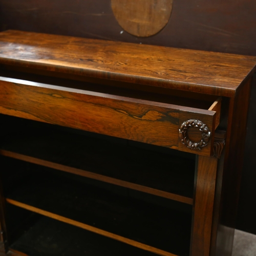 196 - A Regency rosewood open bookcase of small size, with carved laurel wreath bosses and acanthus carved... 