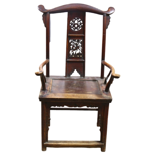 214 - An antique elm Chinese emperor's throne chair, with carved and pierced decoration. Overall 68x118x52... 