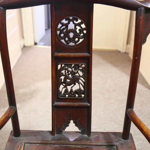 214 - An antique elm Chinese emperor's throne chair, with carved and pierced decoration. Overall 68x118x52... 