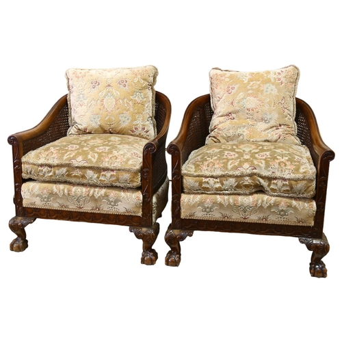 86 - A pair of good quality walnut framed bergere tub chairs, circa 1900, with double cane panels, relief... 