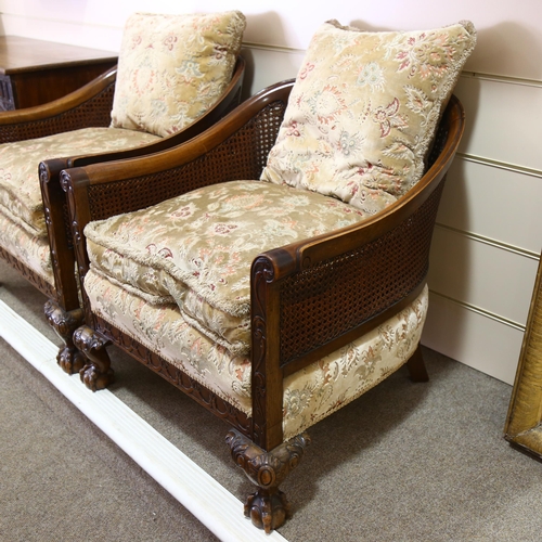 86 - A pair of good quality walnut framed bergere tub chairs, circa 1900, with double cane panels, relief... 