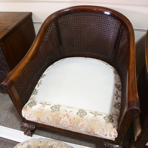 86 - A pair of good quality walnut framed bergere tub chairs, circa 1900, with double cane panels, relief... 