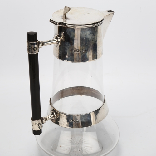 1402 - Dr Christopher Dresser, late Victorian Aesthetic Movement silver and glass Claret jug, with ebonised... 