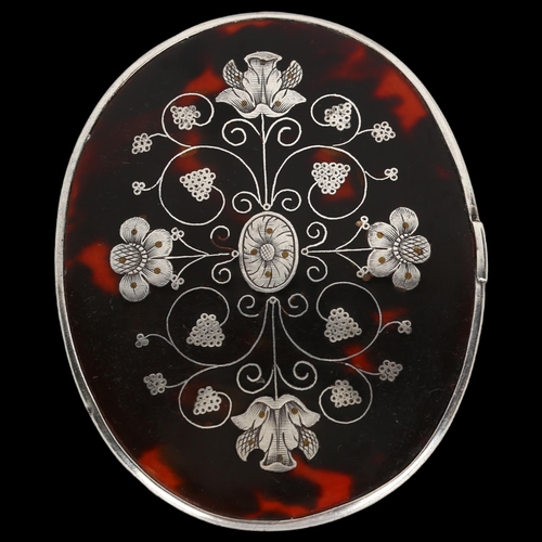 1411 - A small oval tortoiseshell and picquet inlaid travelling mirror, probably mid-19th century, 9cm x 7c... 