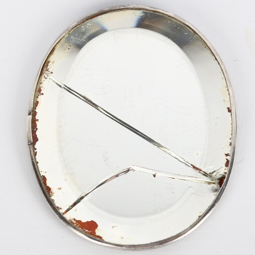 1411 - A small oval tortoiseshell and picquet inlaid travelling mirror, probably mid-19th century, 9cm x 7c... 