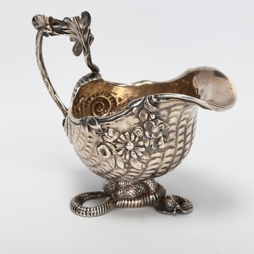 1430 - A fine quality George II cast silver cream jug, in the form of a nautilus shell on serpent base, the... 