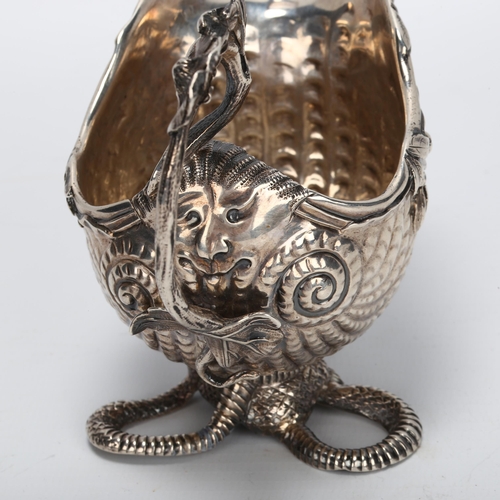 1430 - A fine quality George II cast silver cream jug, in the form of a nautilus shell on serpent base, the... 