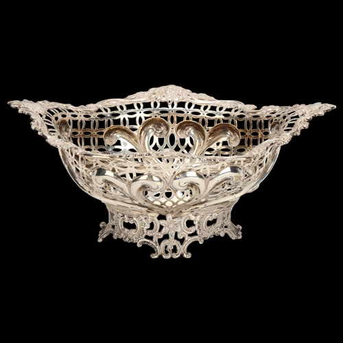 1467 - A Victorian silver table centre fruit bowl of oval form, floral embossed surround with shaped and pi... 