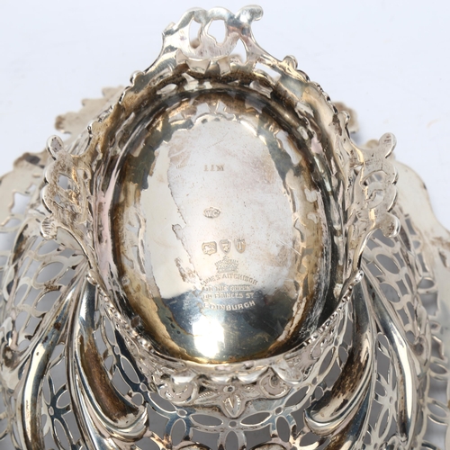 1467 - A Victorian silver table centre fruit bowl of oval form, floral embossed surround with shaped and pi... 