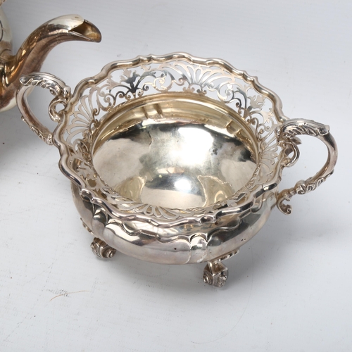 1468 - A Victorian silver teapot and matching sugar bowl, pierced fretwork surrounds on cast scrolled feet,... 