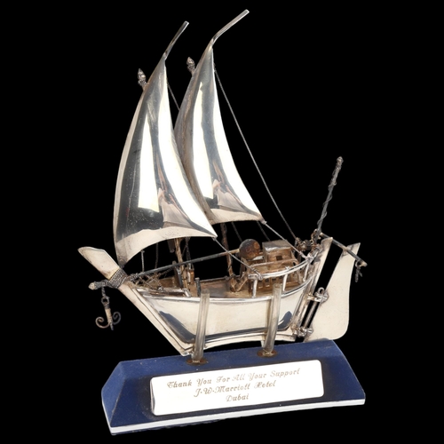 1474 - A Middle Eastern silver model dhow on stand, marked 925 silver, height 23cm, boxed