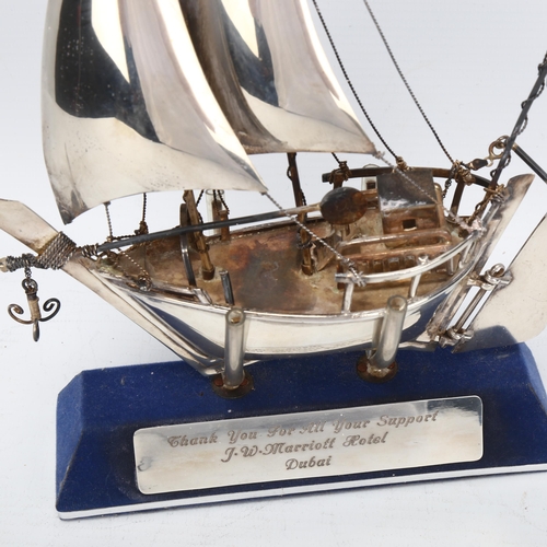 1474 - A Middle Eastern silver model dhow on stand, marked 925 silver, height 23cm, boxed