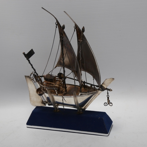 1474 - A Middle Eastern silver model dhow on stand, marked 925 silver, height 23cm, boxed