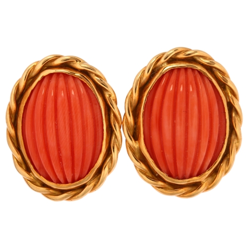 1110 - A pair of late 20th century 18ct gold coral earrings, maker's mark SUE, London 1980, set with rib-cu... 