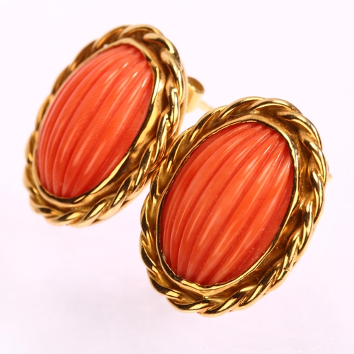 1110 - A pair of late 20th century 18ct gold coral earrings, maker's mark SUE, London 1980, set with rib-cu... 