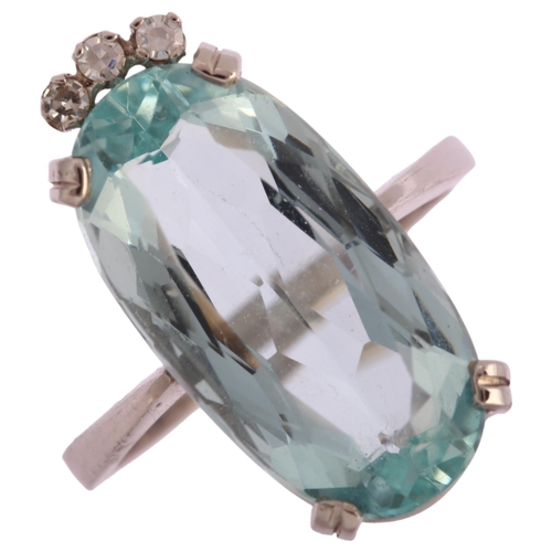 1121 - A modern 18ct white gold aquamarine and diamond dress ring, set with long oval mixed-cut aquamarine ... 