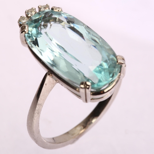 1121 - A modern 18ct white gold aquamarine and diamond dress ring, set with long oval mixed-cut aquamarine ... 