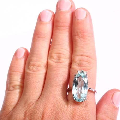 1121 - A modern 18ct white gold aquamarine and diamond dress ring, set with long oval mixed-cut aquamarine ... 