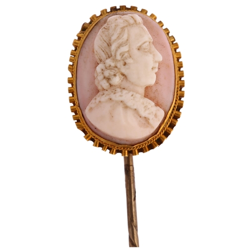 1127 - A Victorian pink coral cameo stickpin, circa 1860, relief carved depicting male profile, in unmarked... 