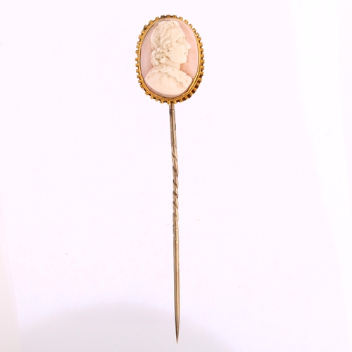 1127 - A Victorian pink coral cameo stickpin, circa 1860, relief carved depicting male profile, in unmarked... 