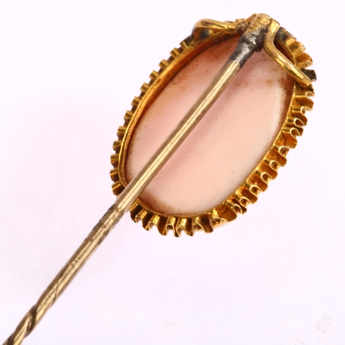 1127 - A Victorian pink coral cameo stickpin, circa 1860, relief carved depicting male profile, in unmarked... 