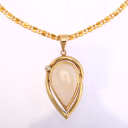 1129 - A 14ct gold opal and diamond pear-drop pendant necklace, on 22ct fancy link chain, set with pear cab... 