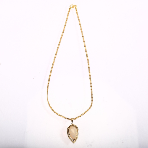 1129 - A 14ct gold opal and diamond pear-drop pendant necklace, on 22ct fancy link chain, set with pear cab... 