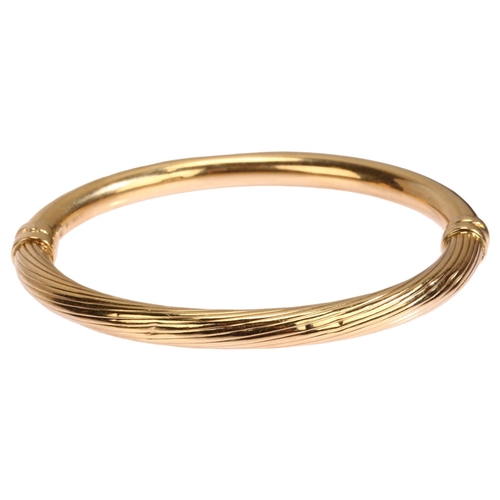 1135 - A 9ct gold hinged bangle, ribbed and polished decoration, band width 6mm, internal circumference app... 