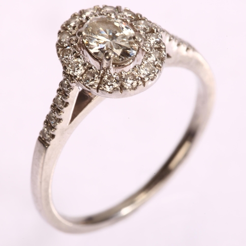 1153 - A modern platinum diamond oval halo cluster ring, London 2014, set with oval and modern round brilli... 