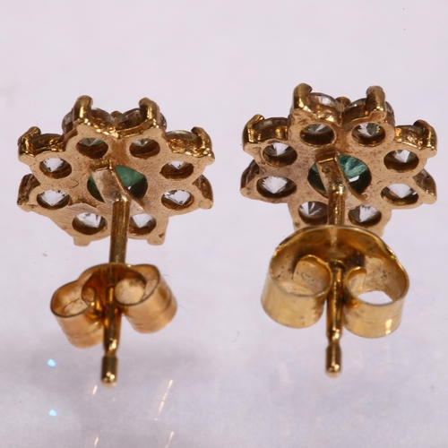 1157 - A pair of emerald and diamond flowerhead cluster earrings, unmarked gold settings with stud fittings... 