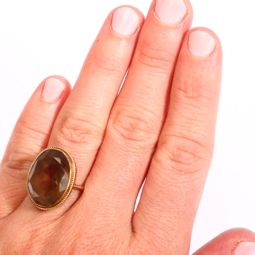 1162 - A mid-20th century 9ct gold smoky quartz dress ring, set with oval mixed-cut quartz, setting height ... 