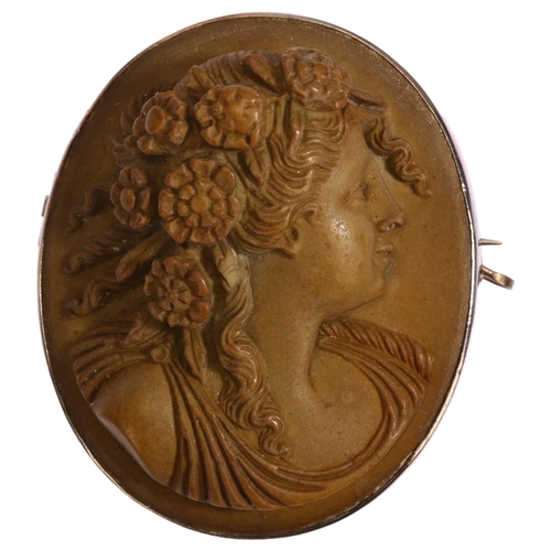 1189 - A Victorian lava cameo brooch, high relief carving depicting female profile, in unmarked white metal... 