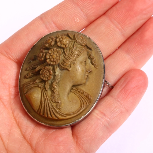 1189 - A Victorian lava cameo brooch, high relief carving depicting female profile, in unmarked white metal... 