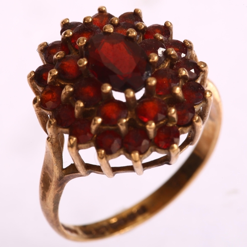 1197 - A late 20th century 9ct gold garnet oval cluster ring, set with oval mixed and round-cut garnets, se... 